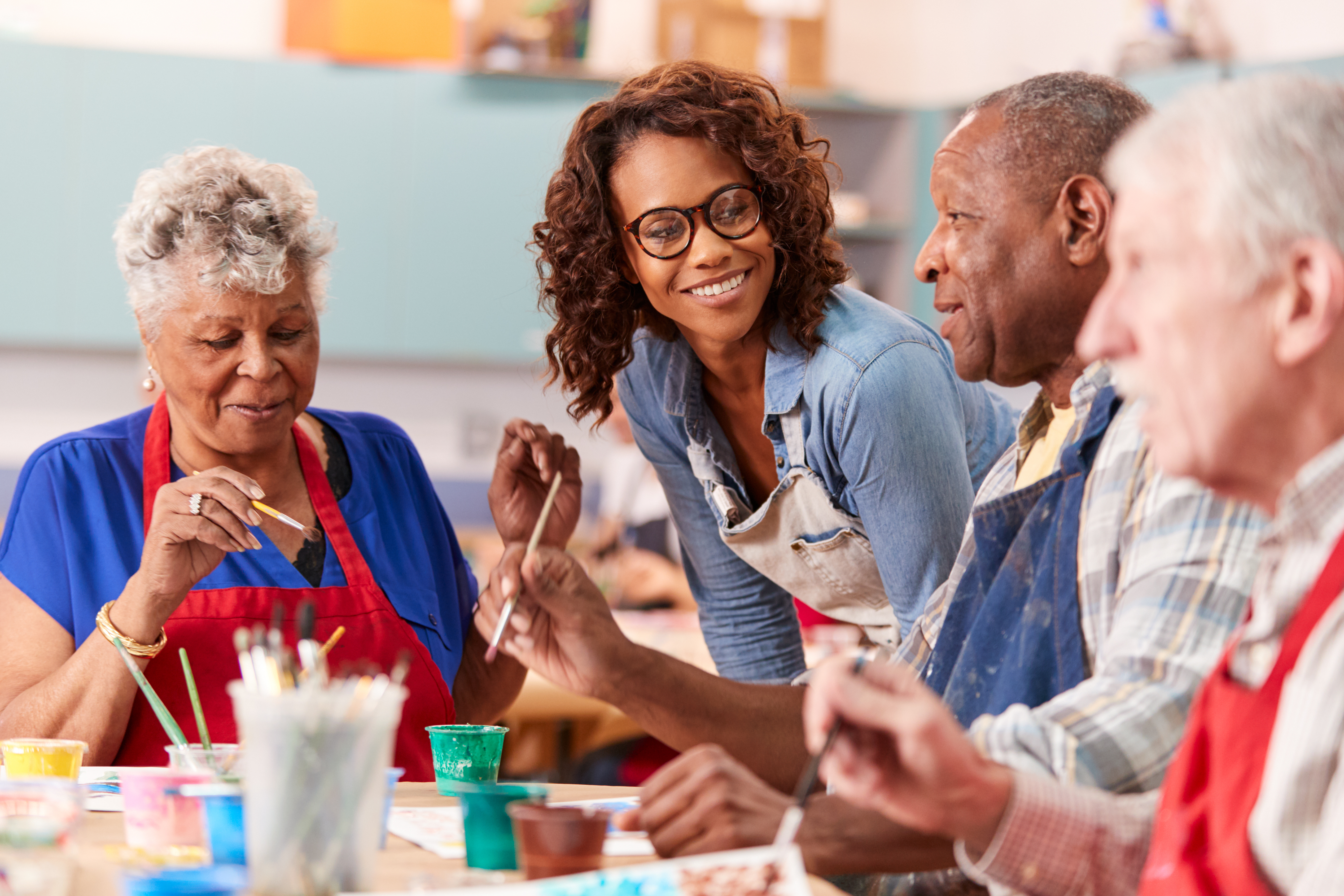 Staff helping a participant at an adult day care center
